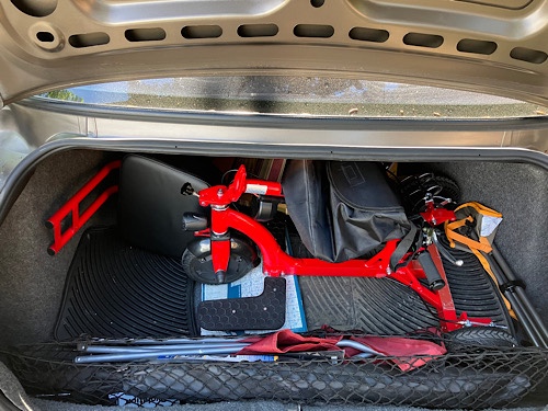 Close up of the Mini in the trunk of a 2003 Buick Century, showing a large amount of space around the scooter in the trunk.